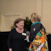Jane Ritter smiling and talking with other event guest
